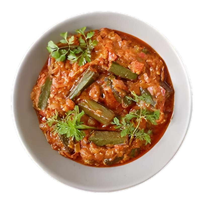 Overhead view of an Indian okra curry with tomatoes and cilantro in a white bowl.